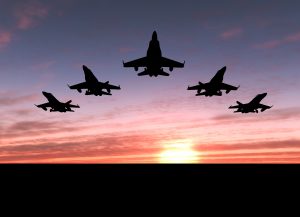 fighter jets in formation at sunset