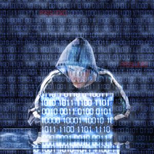 Hacker typing on a laptop with binary code in background