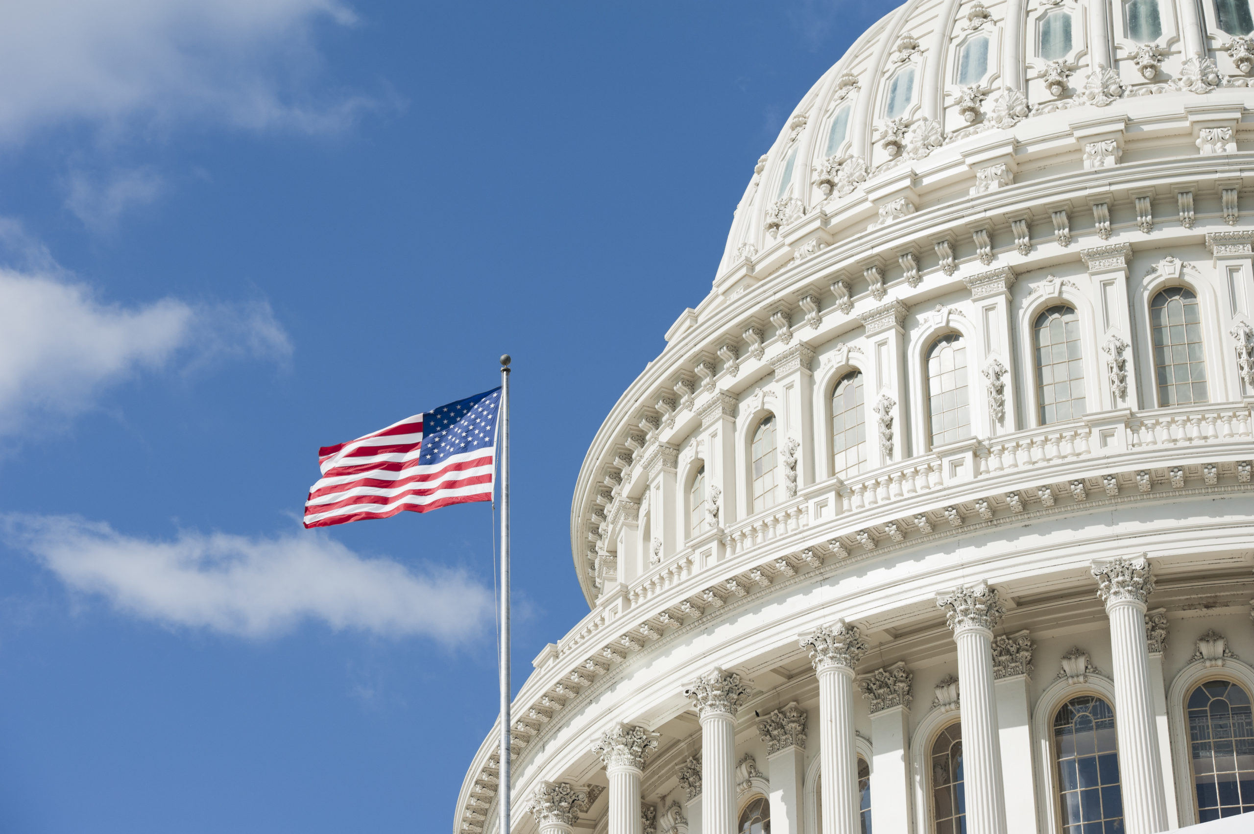 American flag waving in front of Capitol Hill